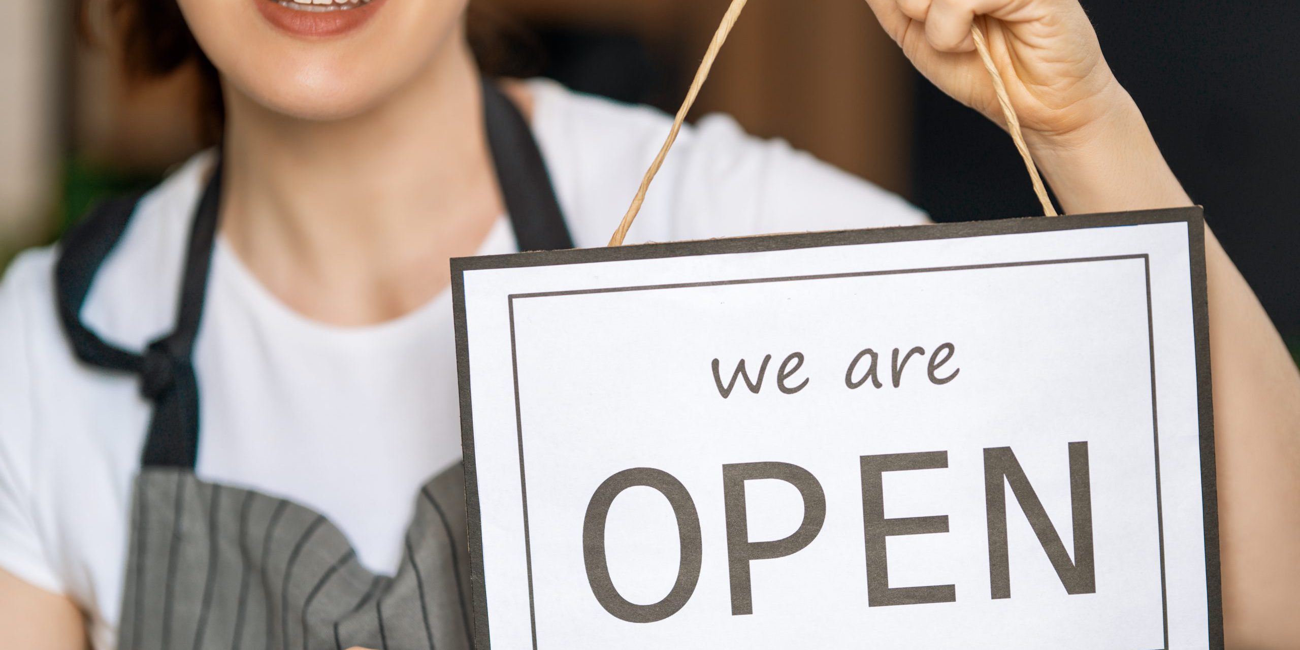 business-owner-holding-the-sign-for-the-reopening