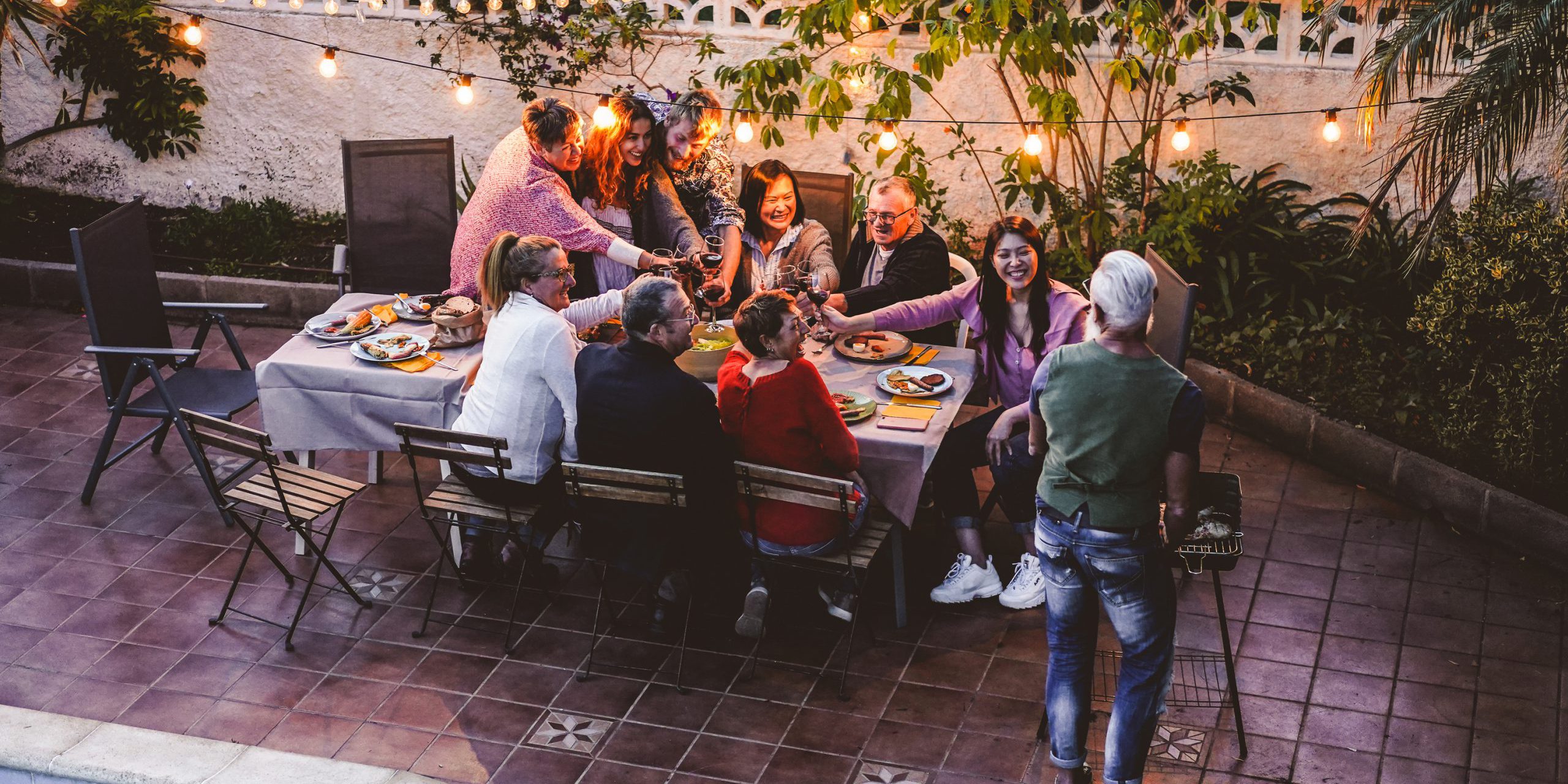 Happy,Family,Eating,And,Cheering,With,Red,Wine,At,Barbecue