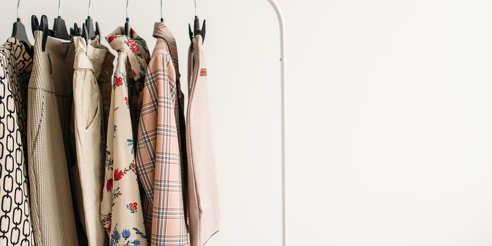 Rack,With,Capsule,Clothes,In,Beige,Colors,Closeup clothes on hangers